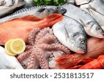 Whole fresh raw octopus, fish and other sea food as background, closeup