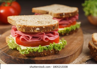 Whole Grain Bread Sandwich With Salami, Tomato, Cheese And Fresh Lettuce