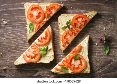 whole grain bread sandwich topped  with fresh tomato sliced and cheese