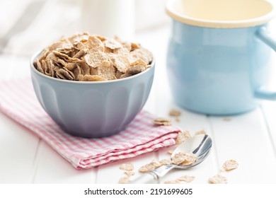Whole grain cereal flakes. Wholegrain breakfast cereals in bowl on a kitchen table. - Shutterstock ID 2191699605