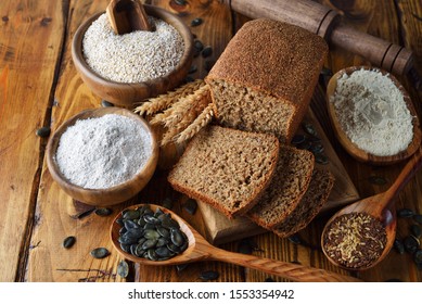 Whole grain diet bread with amaranth on a brown background - Shutterstock ID 1553354942