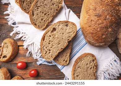 Whole grain homemade sourdough bread on rustic background, top view - Powered by Shutterstock