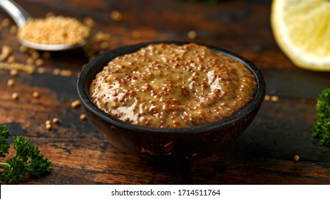 Whole Grain Mustard In Bowl On Wooden Table.