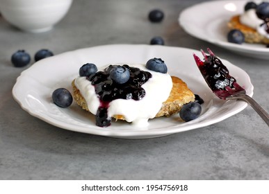 Whole Grain Pancakes With Blueberries,joghurt And Jam On White Plate