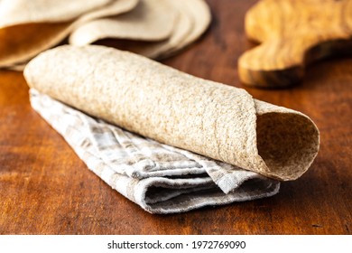 Whole Grain Tortilla Wraps On Wooden Table.