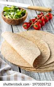 Whole Grain Tortilla Wraps On Wooden Table.