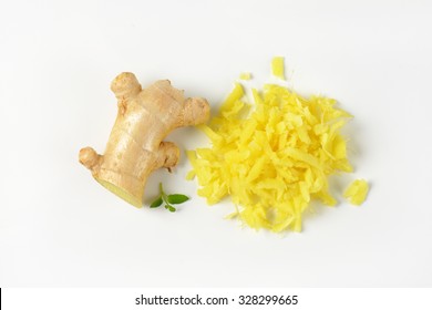 Whole And Grated Fresh Ginger On White Background