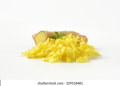 Whole And Grated Fresh Ginger On White Background