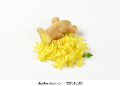 Whole And Grated Fresh Ginger On White Background