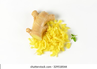 Whole And Grated Fresh Ginger On White Background