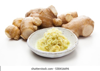 Whole And Grated Ginger On White Background