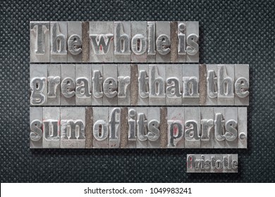 The whole is greater than the sum of its parts - ancient Greek philosopher Aristotle quote made from metallic letterpress on dark background