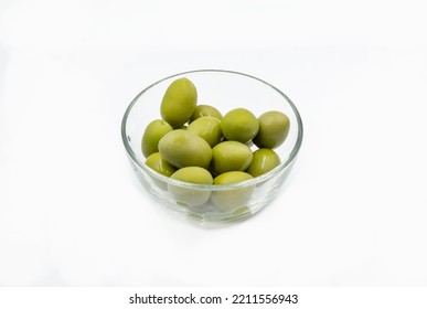 Whole Green Olives Closeup In A Clear Glass Bowl On White