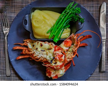 Whole Grilled Lobster On A Plate At A Luxury Restaurant, Served With Cheesy Mashed Potatoes And Fresh Green Asparagus Spears In Vancouver, Canada