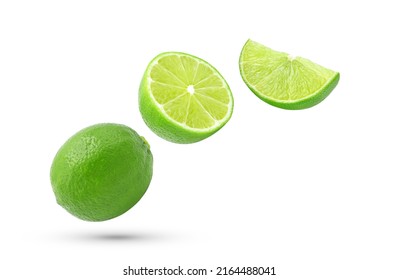 Whole, half and slice fresh lime fruit falling in the air isolated on white background.