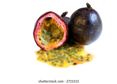 Whole And Halved Passionfruit, With Pulp Spilling Out.