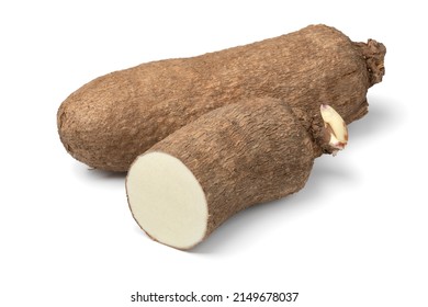 Whole and halved raw African yam isolated on white background