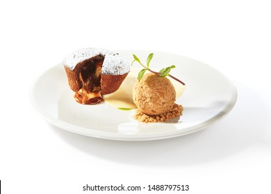Whole hot chocolate fondant with ice cream ball and condense milk on white plate isolated. Restaurant dessert with fresh brownie, muffin or small chocolate cake with crunchy rind and mellow filling - Shutterstock ID 1488797513