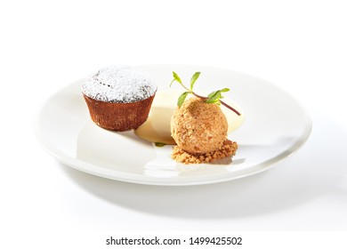 Whole hot chocolate fondant with ice cream ball and condense milk on white plate isolated. Restaurant dessert with fresh brownie, muffin or small chocolate cake with crunchy rind and mellow filling - Shutterstock ID 1499425502