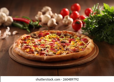 whole italian pizza on wood table with ingredients  - Powered by Shutterstock