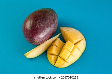 Whole Juicy Mango With A Wedge And Half Cut Into Pieces. View From Above