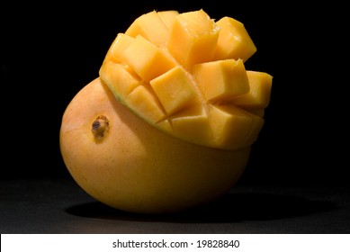 Whole 'Kensington Pride' Mango With Inverted Mango Cheek On Black Under Spotlight