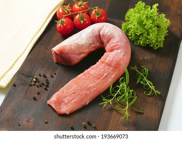 Whole Lean Pork Tenderloin With Vegetable Side Dish, Served On The Wooden Cutting Board