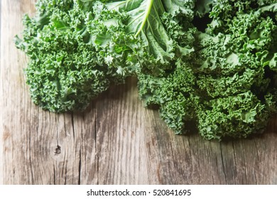 Whole leaves of Italian salad Kale  on a dark wooden table. Country style