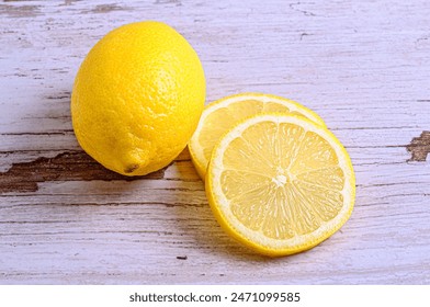 Whole Lemon and Sliced Lemon Stack on Light Wooden Board - Powered by Shutterstock