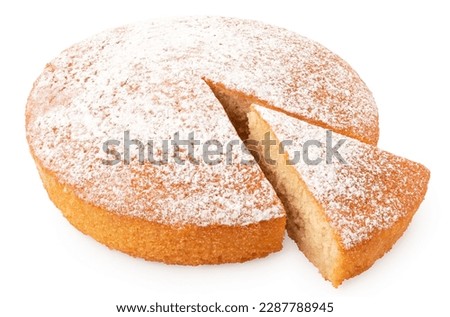 Whole lemon sponge cake with icing sugar topping and cut out wedge isolated on white. High angle.