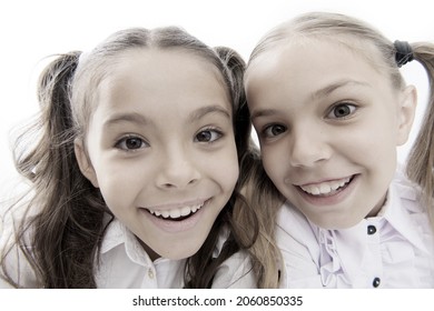 A Whole New Look. Happy School Girls. Adorable Little Girls Smiling Isolated On White. Primary School Girls With Charming Smiles And Long Ponytails. Cute Girls Classmates. Making Selfie