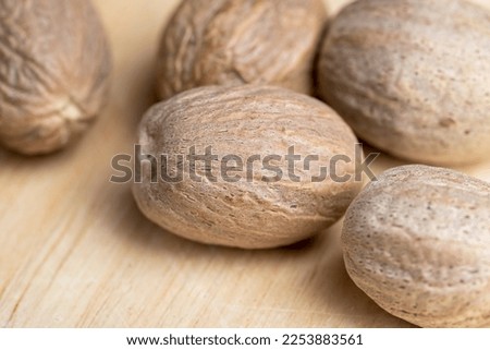 A whole nutmeg fruit on the kitchen table, using the nutmeg spice during cooking