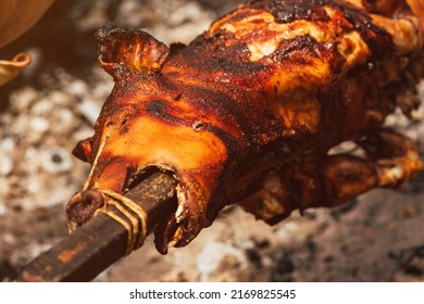 Whole pig roasted on a spit, selective focus