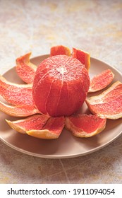 Whole Pink Grapefruit Peeled, On A Plate