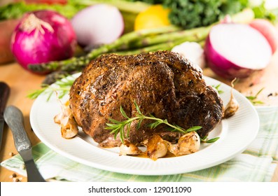 Whole Pot Roast Ready For Serving With Vegetables And Fresh Herbs