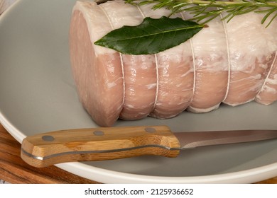 Whole Raw Pork Roast In A Dish On A Wooden Board 