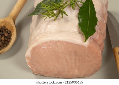 Whole Raw Pork Roast In A Dish On A Wooden Board 