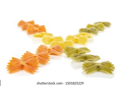 Lot Of Whole Red, Yellow And Green Uncooked Farfalle In X Shape Isolated On White Background