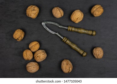 Lot Of Whole Ripe Brown Walnut With Old Nutcracker Flatlay On Grey Stone