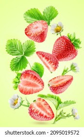 A Whole Ripe Strawberry, Its Pieces, Leaves And Flowers Levitate Isolated On A Light Green Background.