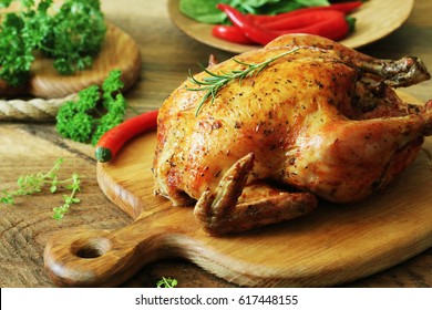 Whole roasted chicken on cutting board