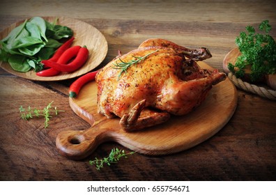 Whole roasted chicken on cutting board. Vintage photo