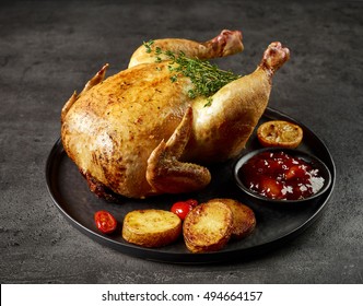 whole roasted chicken on dark grey kitchen table