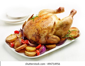 whole roasted chicken on white plate