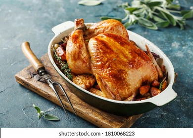 Whole roasted chicken with vegetables on wooden cutting board - Powered by Shutterstock