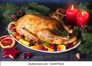 Whole Roasted Duck With Oranges, Berries And Herbs. Christmas Decorations. Dish For Christmas Eve