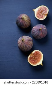 Whole And Sliced Figs On A Dark Blue Wooden Surface, Above View