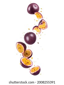 Whole and sliced fresh passion fruit (passiflora) in the air on a white background - Shutterstock ID 2008255391