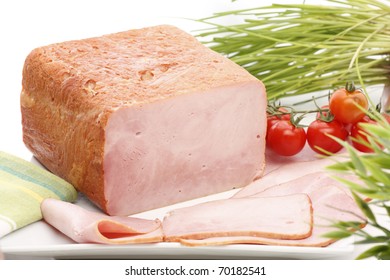 Whole And Sliced Ham With Tomato And Chives