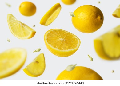 Whole And Sliced Lemons Falling In The Air. Food Levitation.